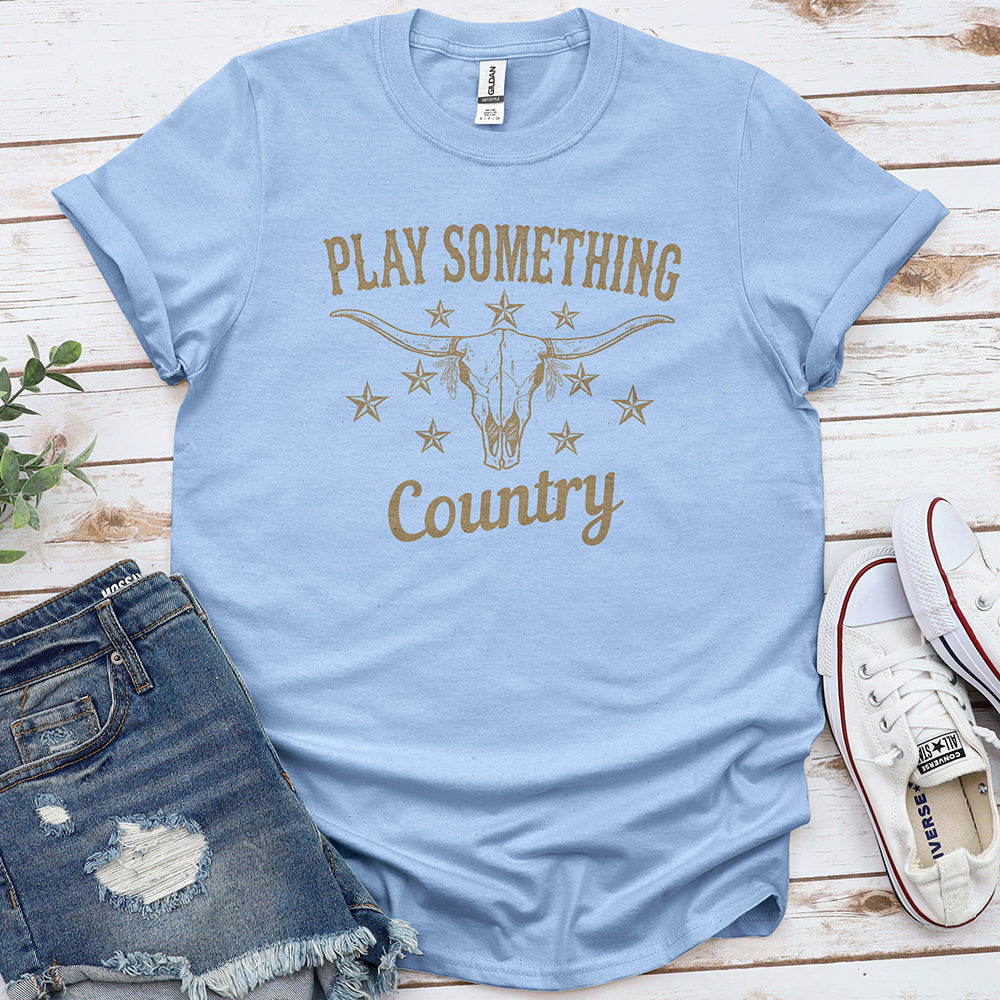 Light blue country graphic tee with bull skull and stars, styled with denim shorts and sneakers