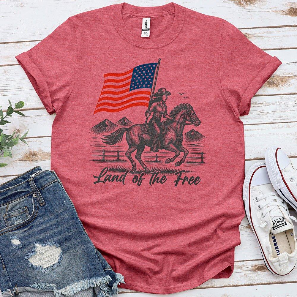 Red Proud & Free t-shirt with cowboy on horse holding American flag, denim shorts, white sneakers