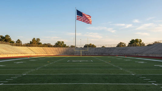 American flag raised above an empty football field before kickoff