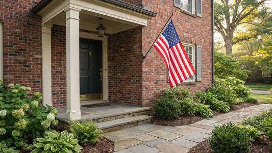 American flag displayed upright from a secure wall bracket on a brick porch