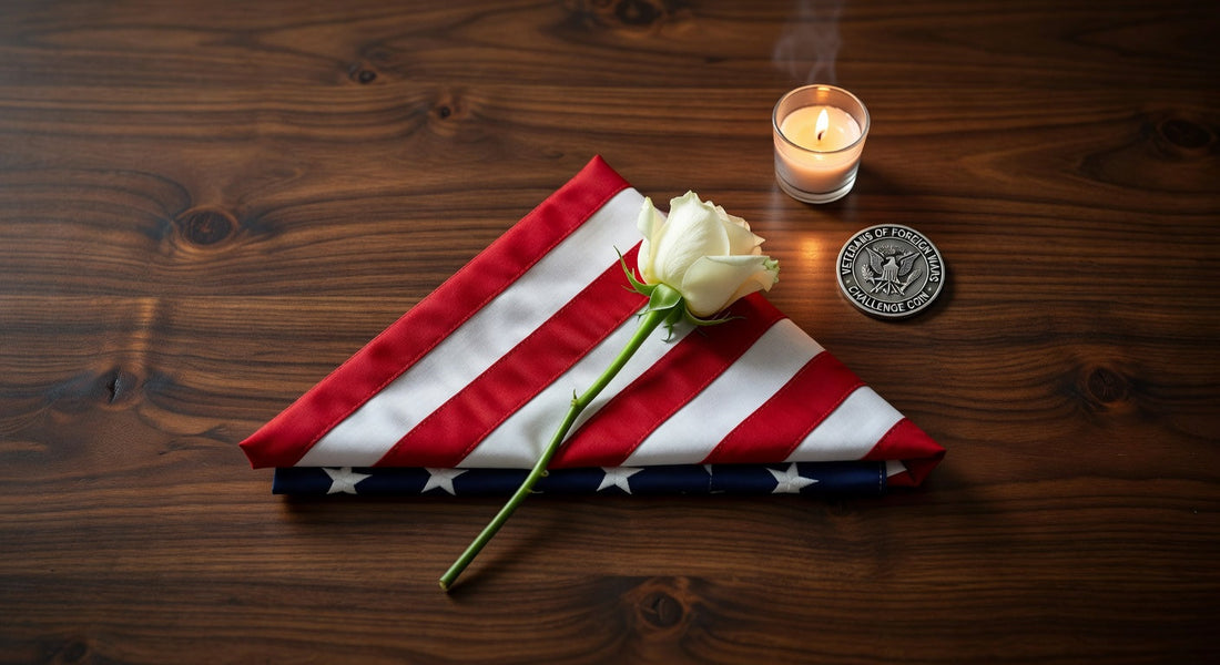 Folded American flag with white rose, Veterans coin, and memorial candle on wooden table