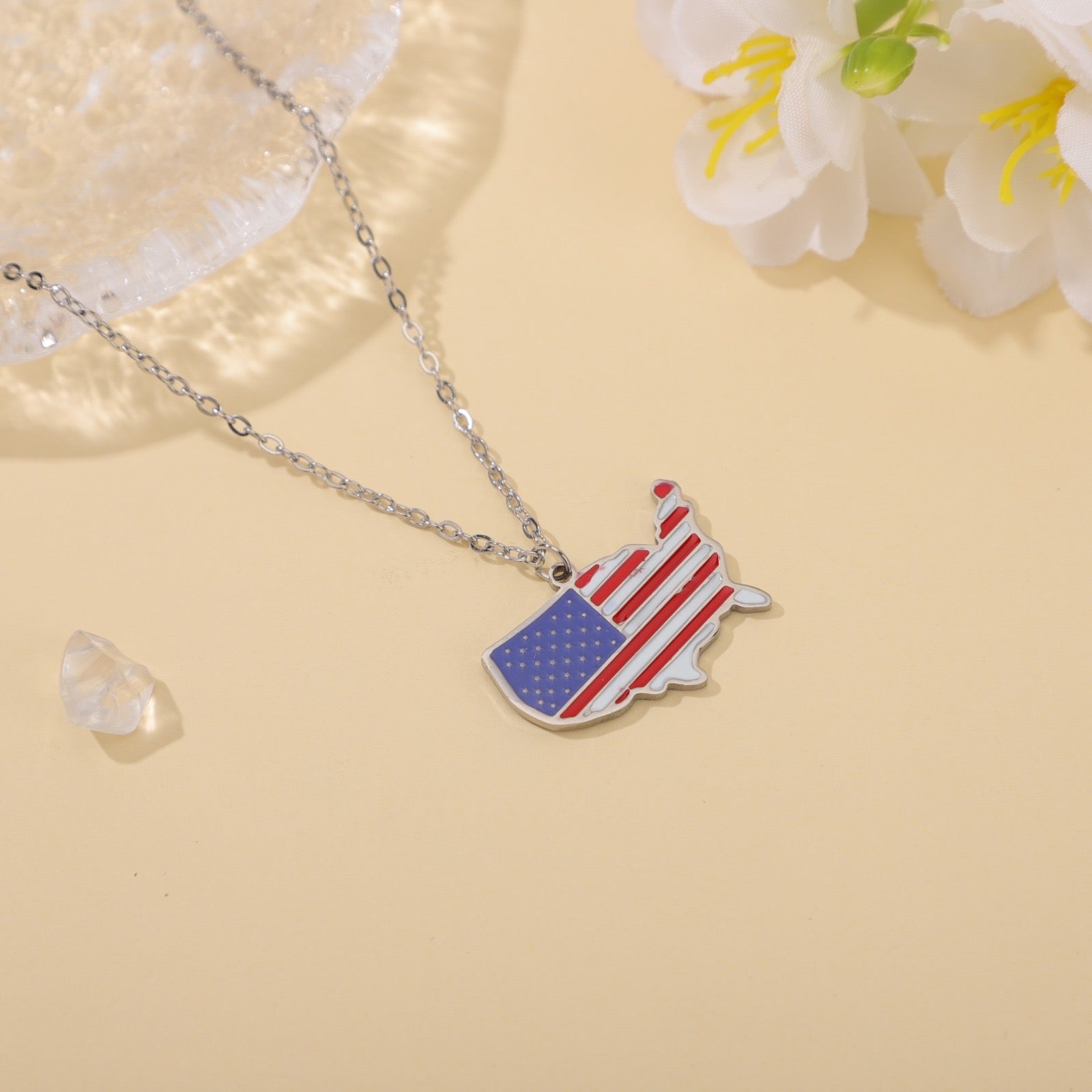 USA map pendant necklace with American flag design on light background, patriotic jewelry
