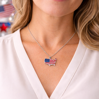 Woman wearing USA map American flag pendant necklace with soft bokeh background