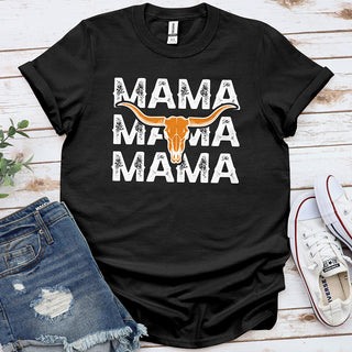 Black graphic tee with 'MAMA' text and longhorn skull, styled with denim shorts and sneakers