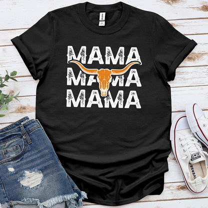 Black graphic tee with 'MAMA' text and longhorn skull, styled with denim shorts and sneakers