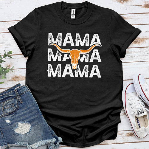 Black graphic tee with 'MAMA' text and longhorn skull, styled with denim shorts and sneakers
