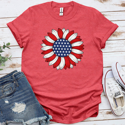Heather red t-shirt with patriotic sunflower graphic, stars and stripes, flat lay with denim shorts