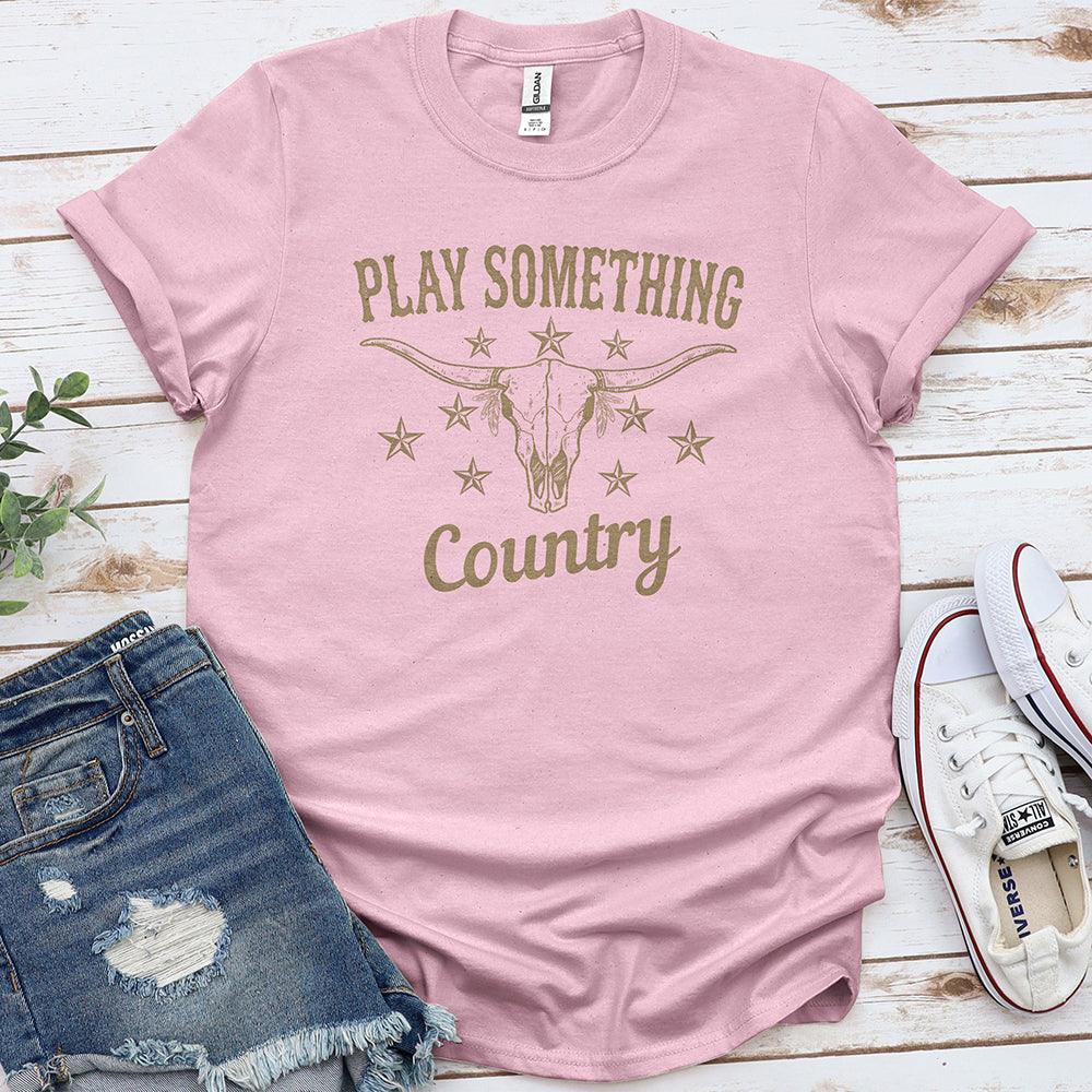 Light pink country music graphic tee with bull skull and stars, styled with denim shorts