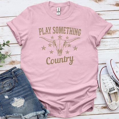 Light pink country music graphic tee with bull skull and stars, styled with denim shorts