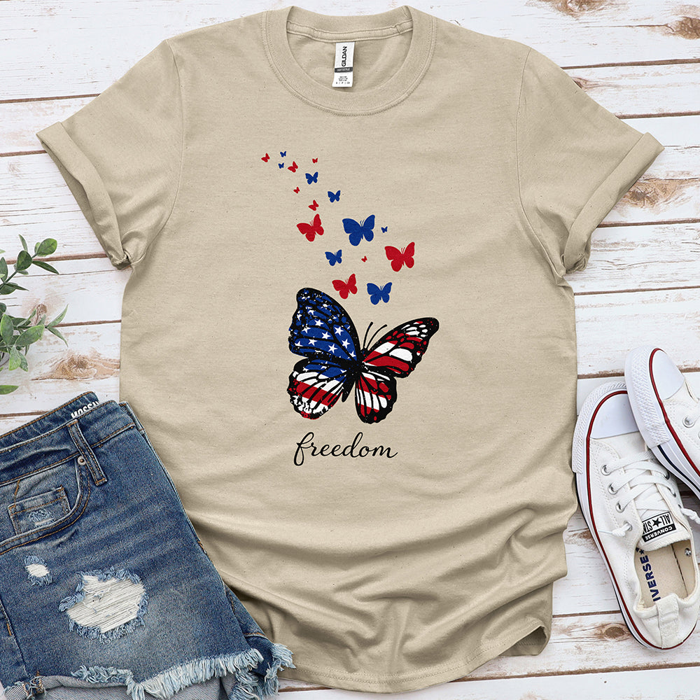 Beige t-shirt with patriotic butterfly and freedom text, styled with denim shorts and sneakers