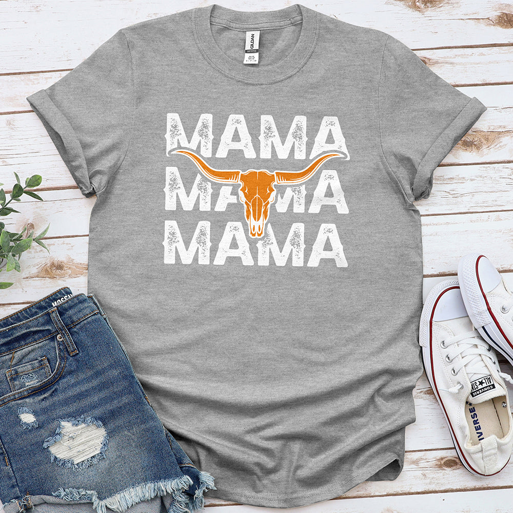 Grey graphic tee with 'MAMA' text and longhorn skull, styled with denim shorts and sneakers