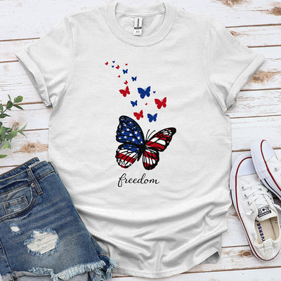 White t-shirt with USA flag butterfly, red and blue butterflies, and 'freedom' text.