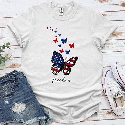 White t-shirt with USA flag butterfly, red and blue butterflies, and 'freedom' text.