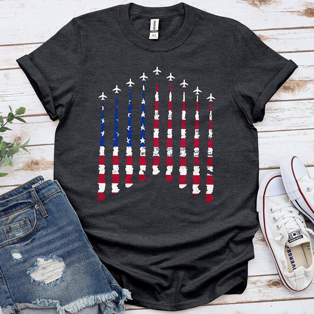 Charcoal tee with airplanes and distressed American flag print, laid with denim shorts and sneakers.