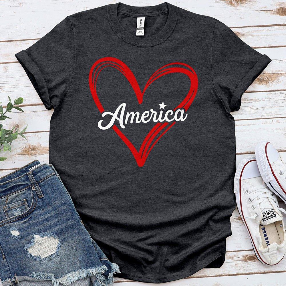 Dark gray Proud & Free t-shirt with red heart and America text, styled with denim shorts and sneakers