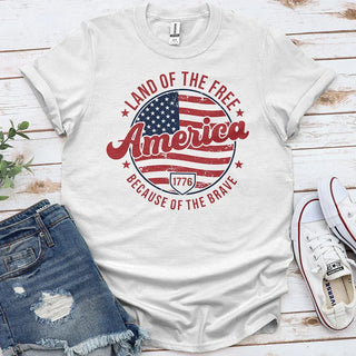 White America patriotic t-shirt with US flag, denim shorts, and Converse sneakers flat lay