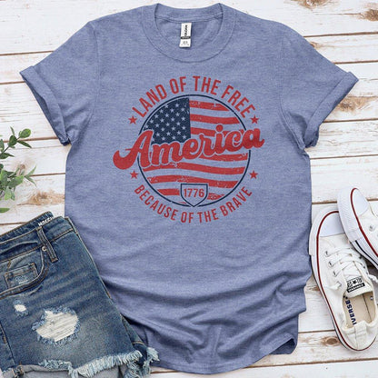 Blue America patriotic t-shirt with flag design, distressed denim shorts, and white sneakers