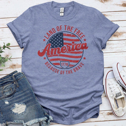 Blue America patriotic t-shirt with flag design, distressed denim shorts, and white sneakers