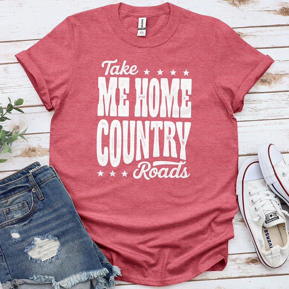 Red Take Me Home Country Roads t-shirt styled with denim shorts and white sneakers on wooden background