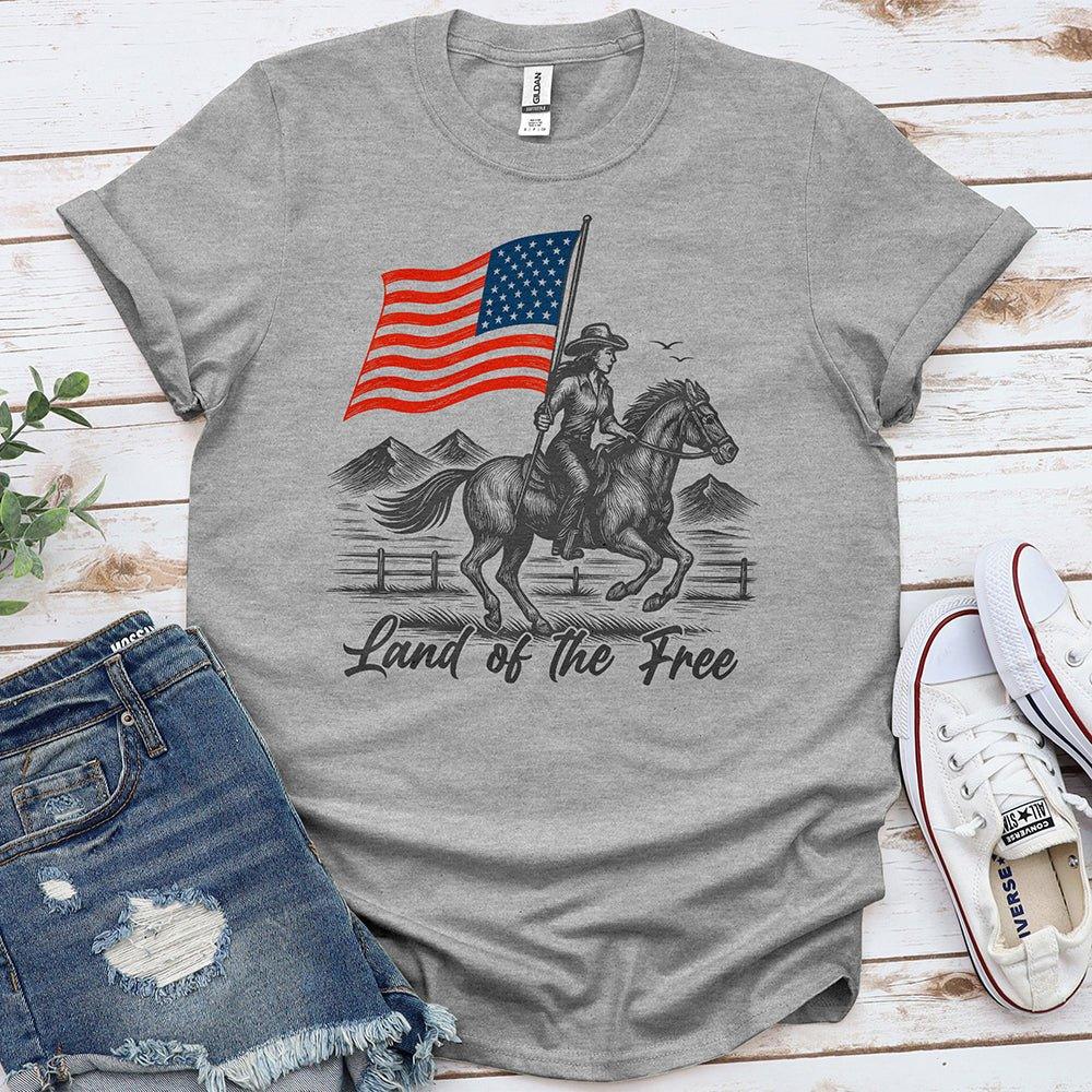 Gray t-shirt with cowboy riding horse, holding US flag, and 'Land of the Free' text