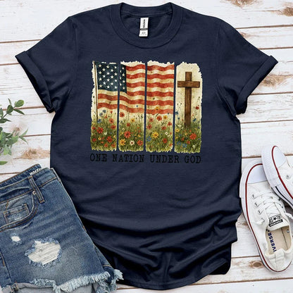 Navy graphic tee with American flag, cross, wildflowers, and 'One Nation Under God' text