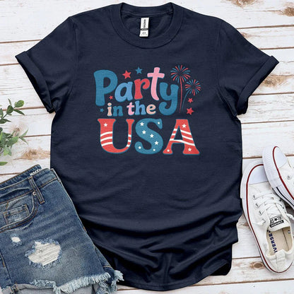 Navy Party in the USA graphic tee with stars, fireworks, denim shorts, and white sneakers
