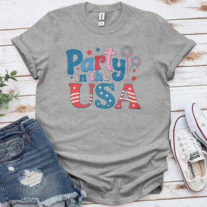 Gray Party in the USA t-shirt with red, white, and blue print, denim shorts, white sneakers
