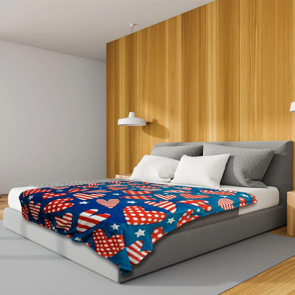 Patriotic hearts plush blanket with red, white, and blue design on a modern bed