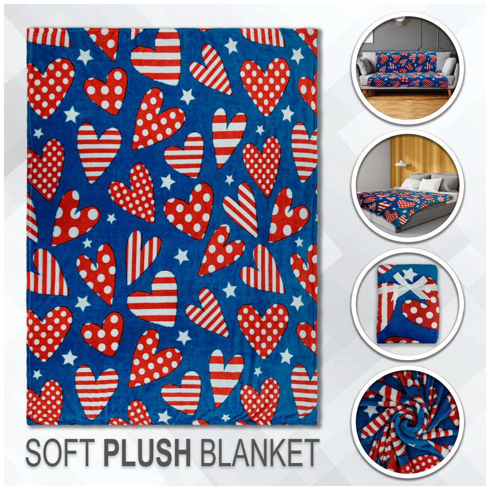 Patriotic hearts plush blanket with red, white, and blue pattern, displayed on bed and sofa.