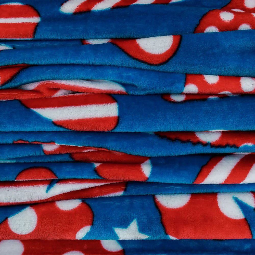 Soft plush patriotic blanket with red, white, and blue hearts, folded stacked view