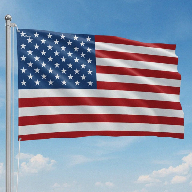 American flag waving on a flagpole against a blue sky
