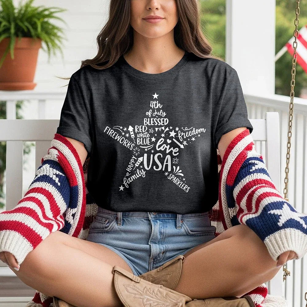 Woman in 'Star of Freedom' USA tee and flag sweater on porch, patriotic summer fashion