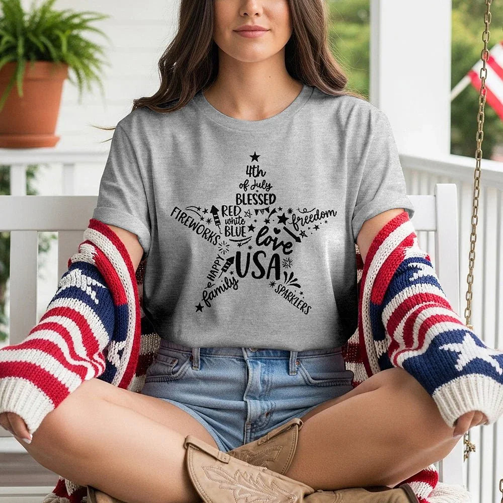 Woman wearing Star of Freedom tee with USA, 4th of July, and patriotic words, on porch