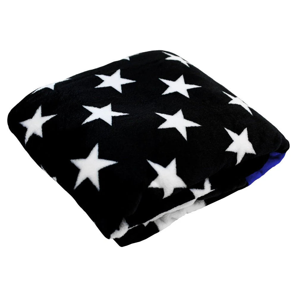 Folded plush blanket with black fabric and white stars, visible blue edge, Proud & Free