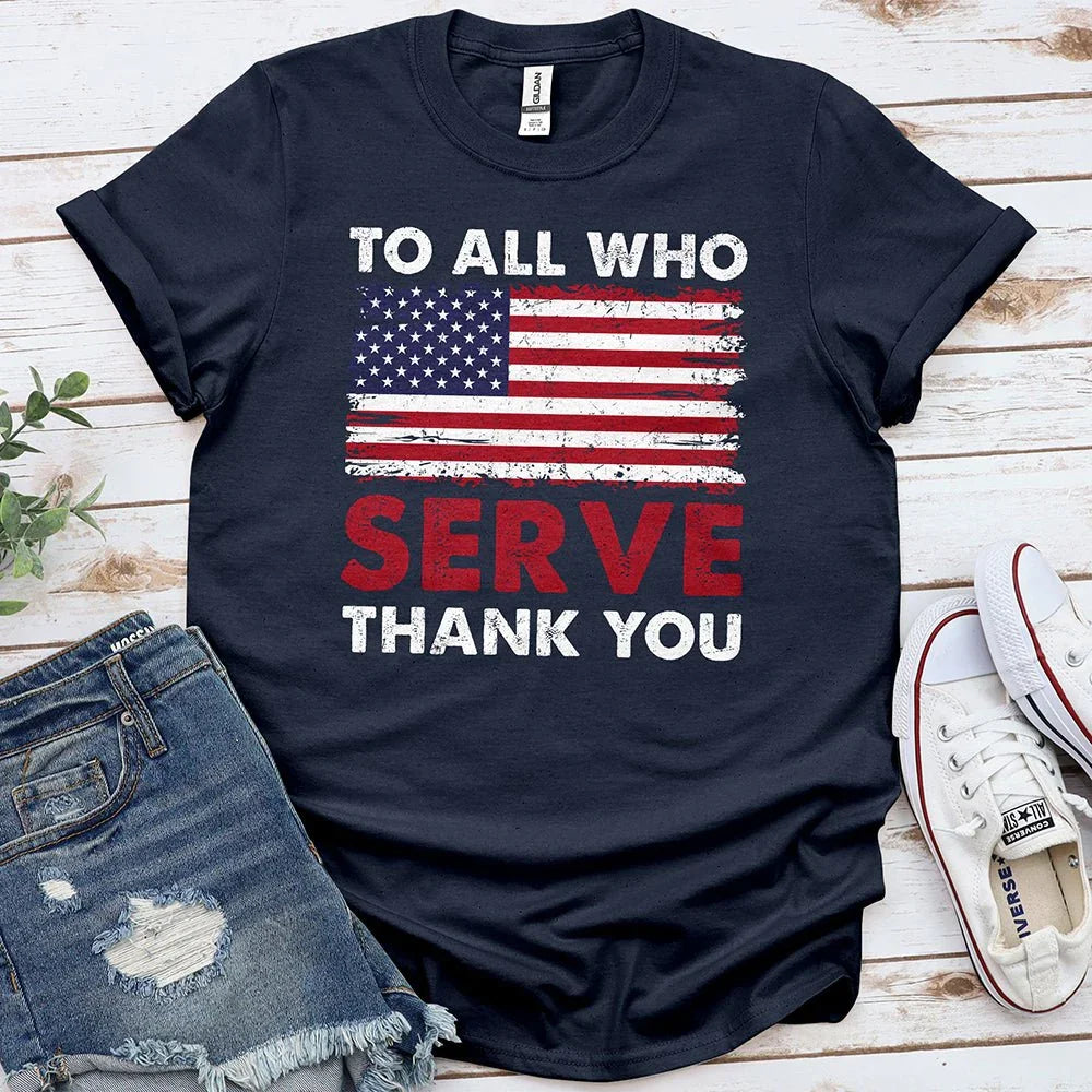 Navy blue t-shirt with distressed US flag and 'To All Who Serve Thank You' message, laid with denim shorts and sneakers