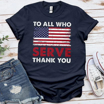 Navy blue t-shirt with distressed US flag and 'To All Who Serve Thank You' message, laid with denim shorts and sneakers