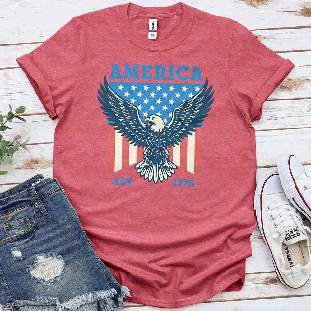 Red America T-shirt with eagle, stars, stripes, EST. 1776, styled with denim shorts and sneakers